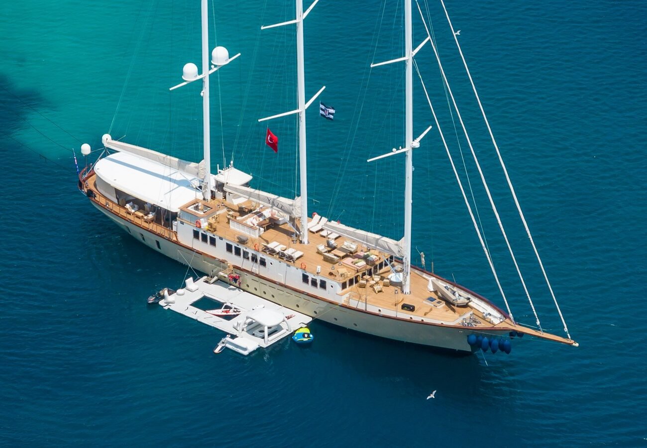 Exterior image of Aegean Yacht YAZZ 56m sailing yacht for sale showcasing her elegant sailing profile, sleek hull lines, and expansive open deck areas.