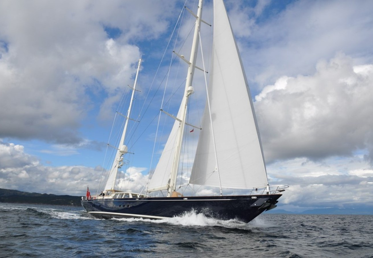 Exterior image of Royal Huisman SURAMA 40.7m sailing yacht for sale showcasing her elegant sailing profile, classic hull lines, and expansive open deck areas.