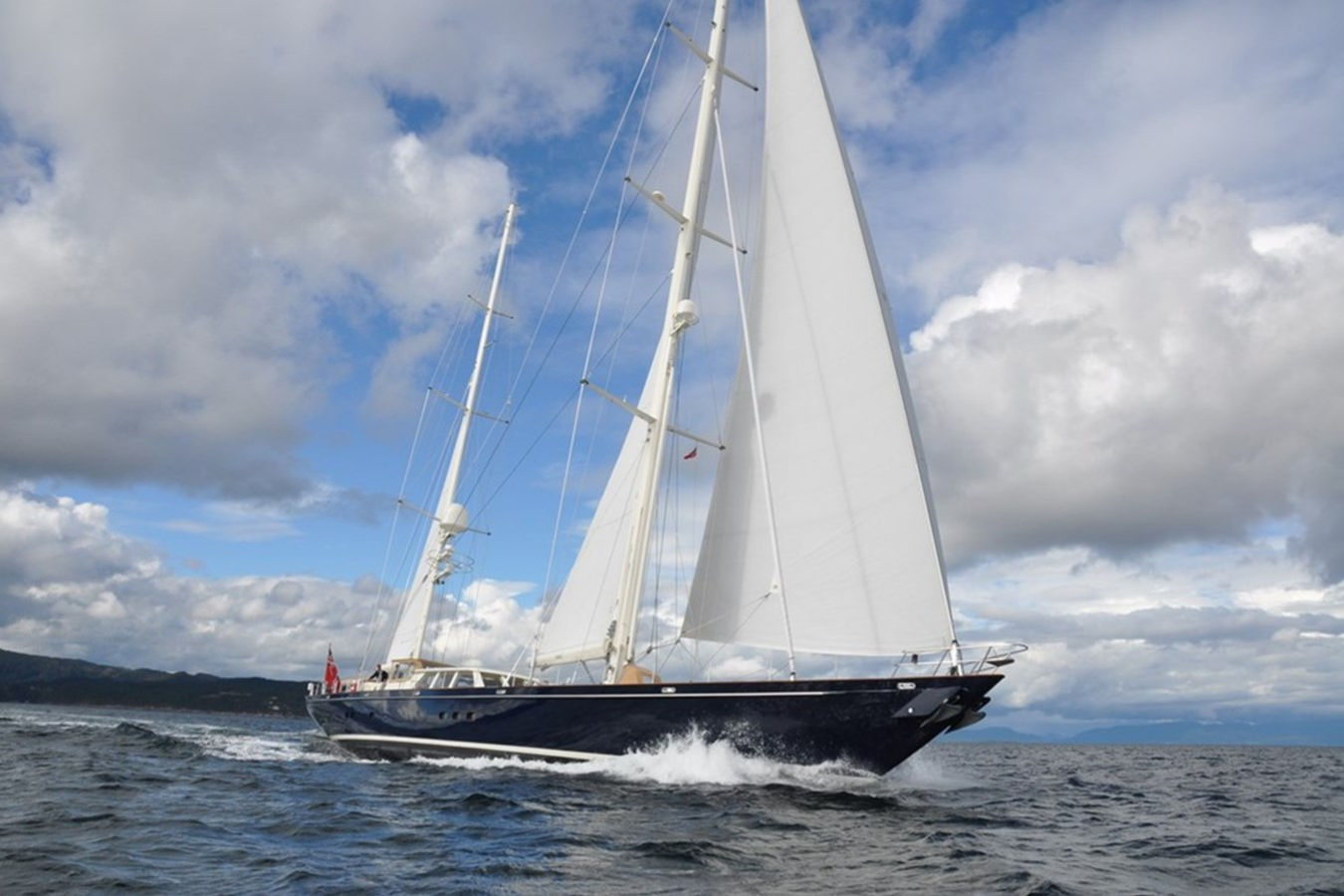 Exterior image of Royal Huisman SURAMA 40.7m sailing yacht for sale showcasing her elegant sailing profile, classic hull lines, and expansive open deck areas.