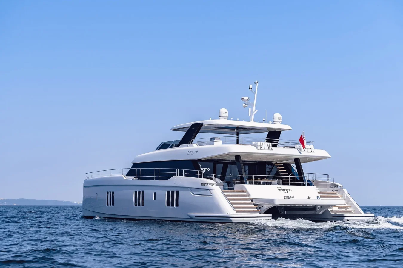 Rear view of Sunreef Yachts 80 Kokomo showcasing its wide swim platform and outdoor lounge areas.