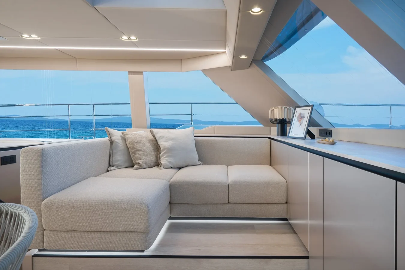 Cozy interior sitting area on Sunreef Yachts 80 Kokomo with plush sofas and elegant décor.