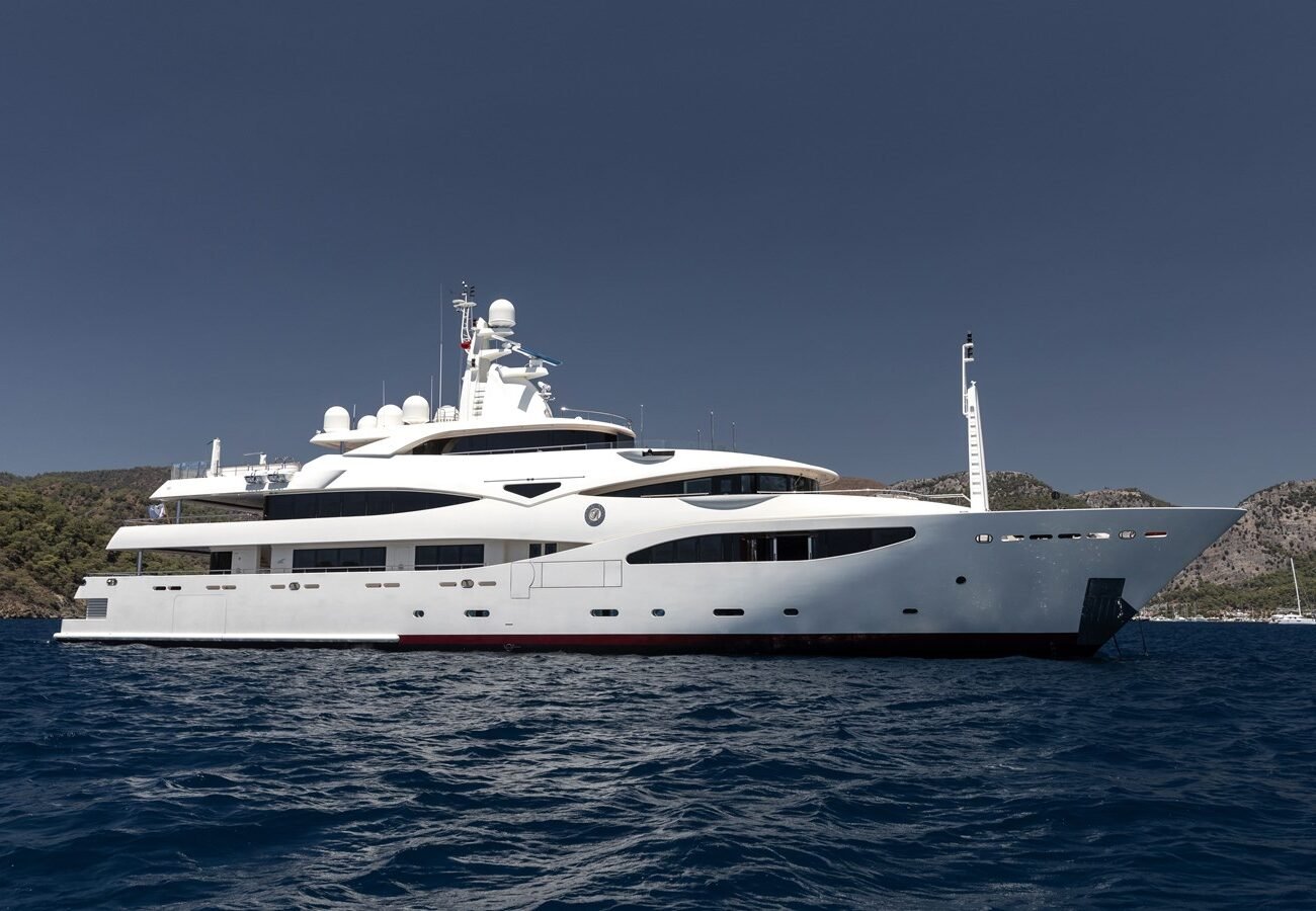 CRN 186 “Richard” superyacht anchored in calm waters with scenic coastline in the background.