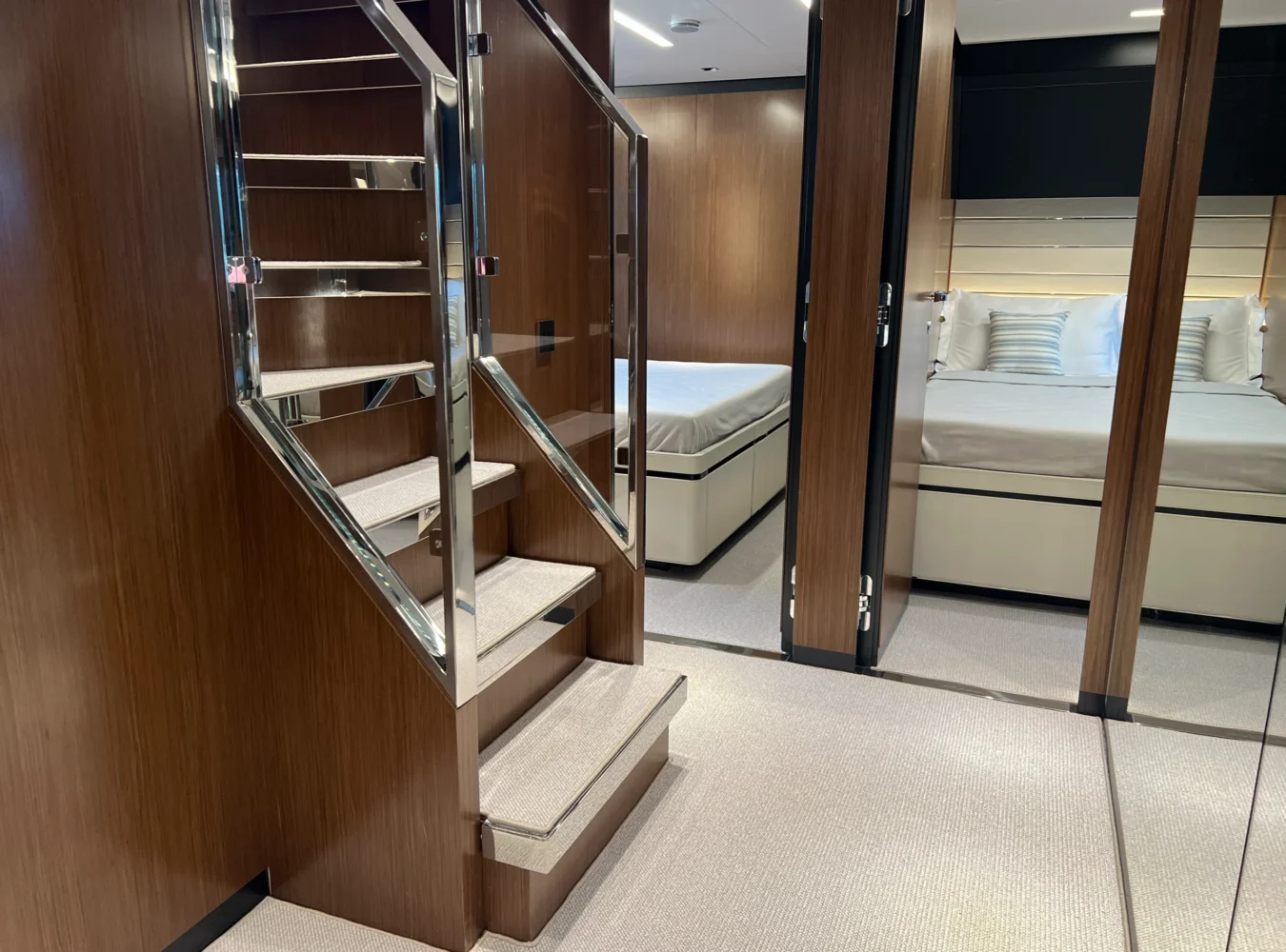 Below deck lobby aboard Riva 102’ Corsaro Super with polished wood finishes and elegant design.