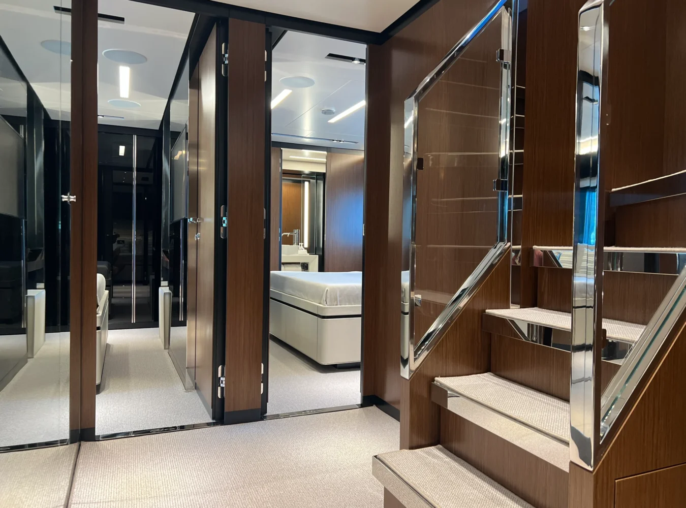 Below deck lobby view on the Riva 102’ Corsaro Super with polished finishes and elegant design.