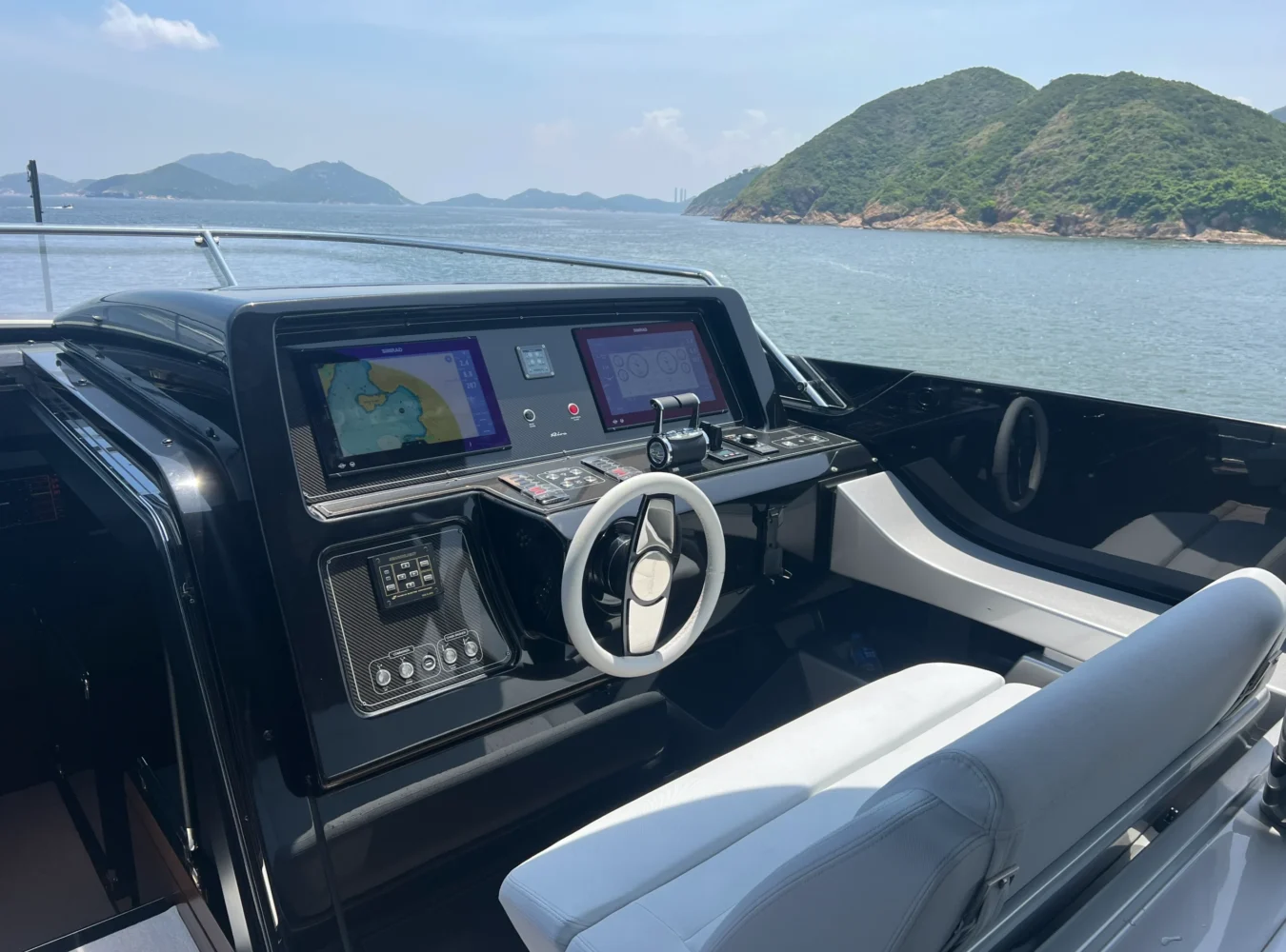 Flybridge helmstation on the Riva 102’ Corsaro Super with modern controls and panoramic sea views.