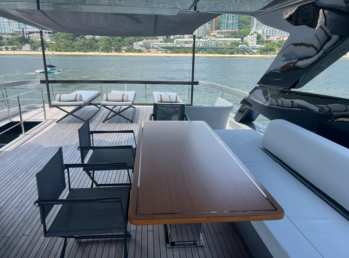 Flybridge dining table aboard Riva 102’ Corsaro Super with elegant seating and open-air sea views.