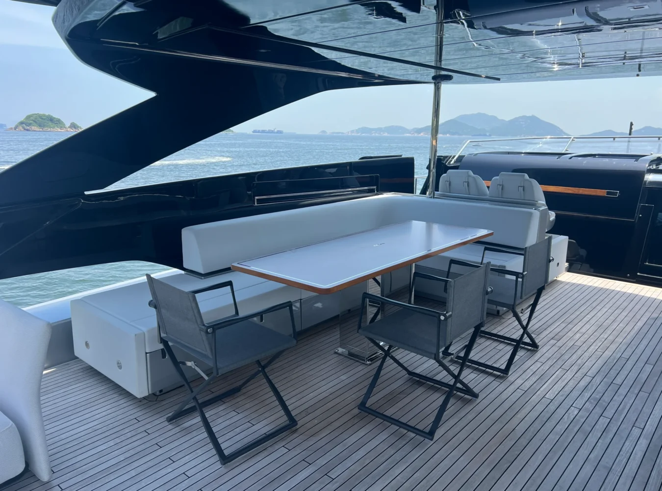 Elegant flybridge dining table aboard Riva 102’ Corsaro Super designed for open-air gatherings.
