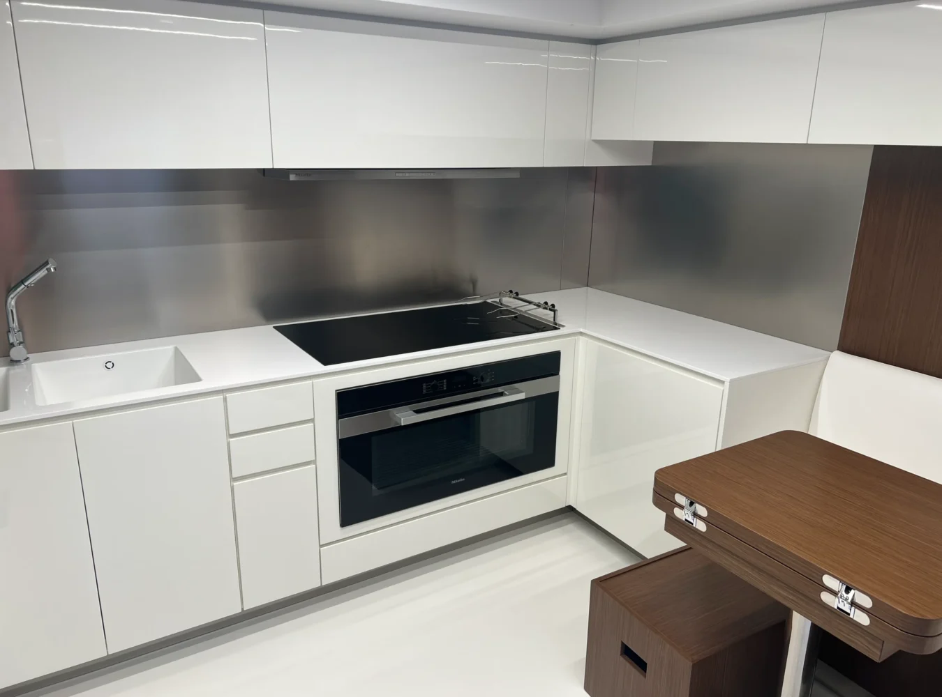 Main deck galley aboard the Riva 102’ Corsaro Super with modern appliances and sleek cabinetry.