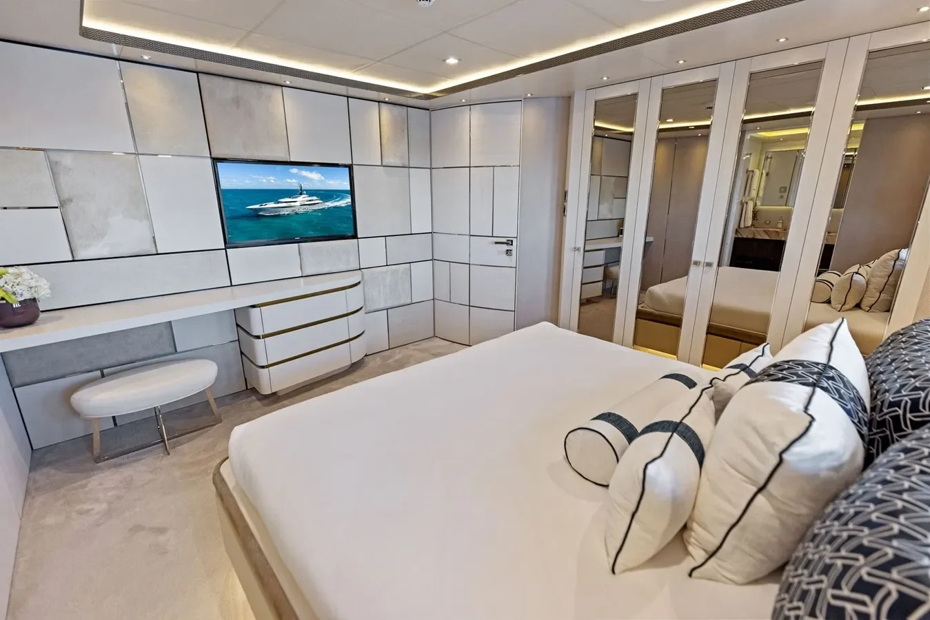 Elegant yacht guest bedroom with refined finishes and cozy ambiance.