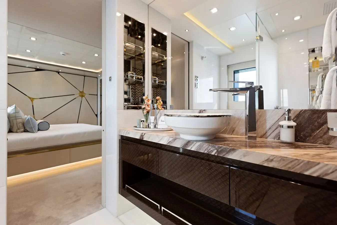 Elegant yacht bathroom with marble finishes, glass shower, and premium fixtures.