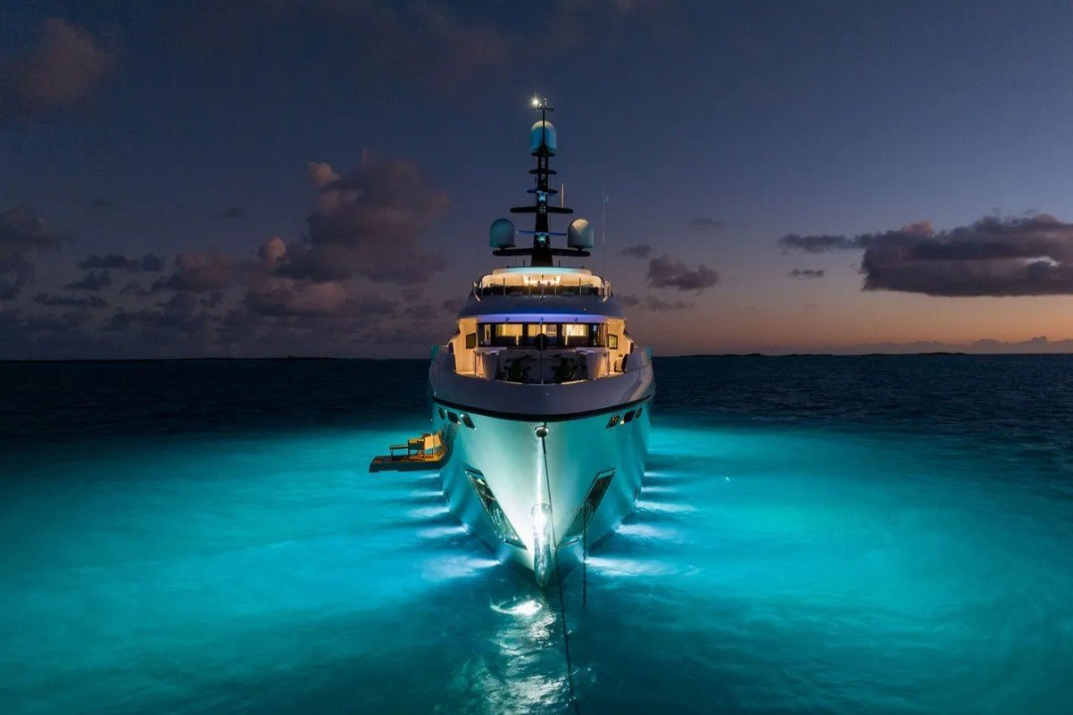 Exterior bow night view of Bilgin Yachts 156 Moonraker with glowing lights and unfolded side platform.