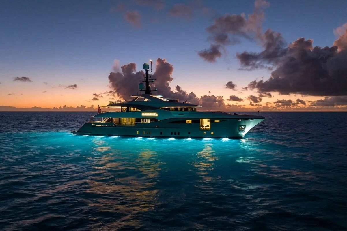 Side night view of Bilgin Yachts 156 Moonraker illuminated with glowing exterior lights.