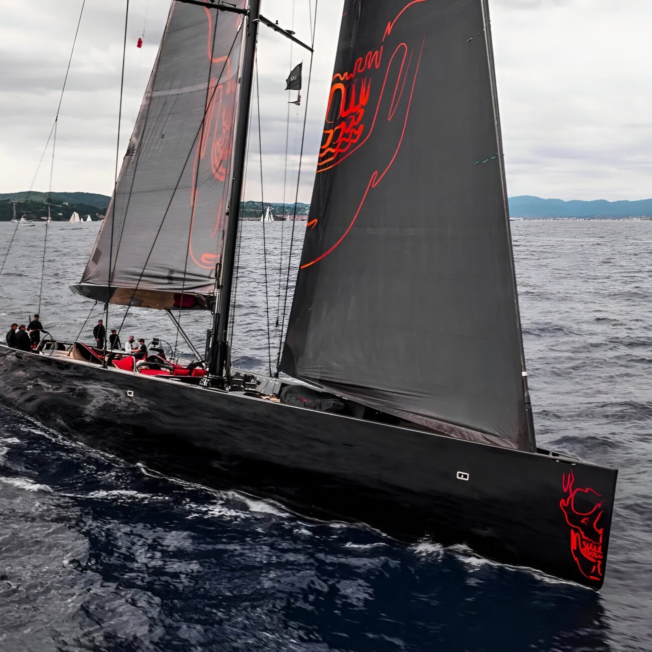 Wally 130 Black Sails cruising in the sea, showcasing her sleek hull and dynamic sailing profile.