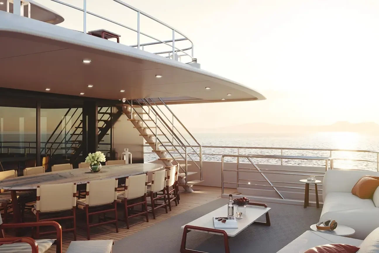 Bridge deck aft dining and lounge area of the Heesen FRIDA 55M yacht at sunset overlooking the ocean