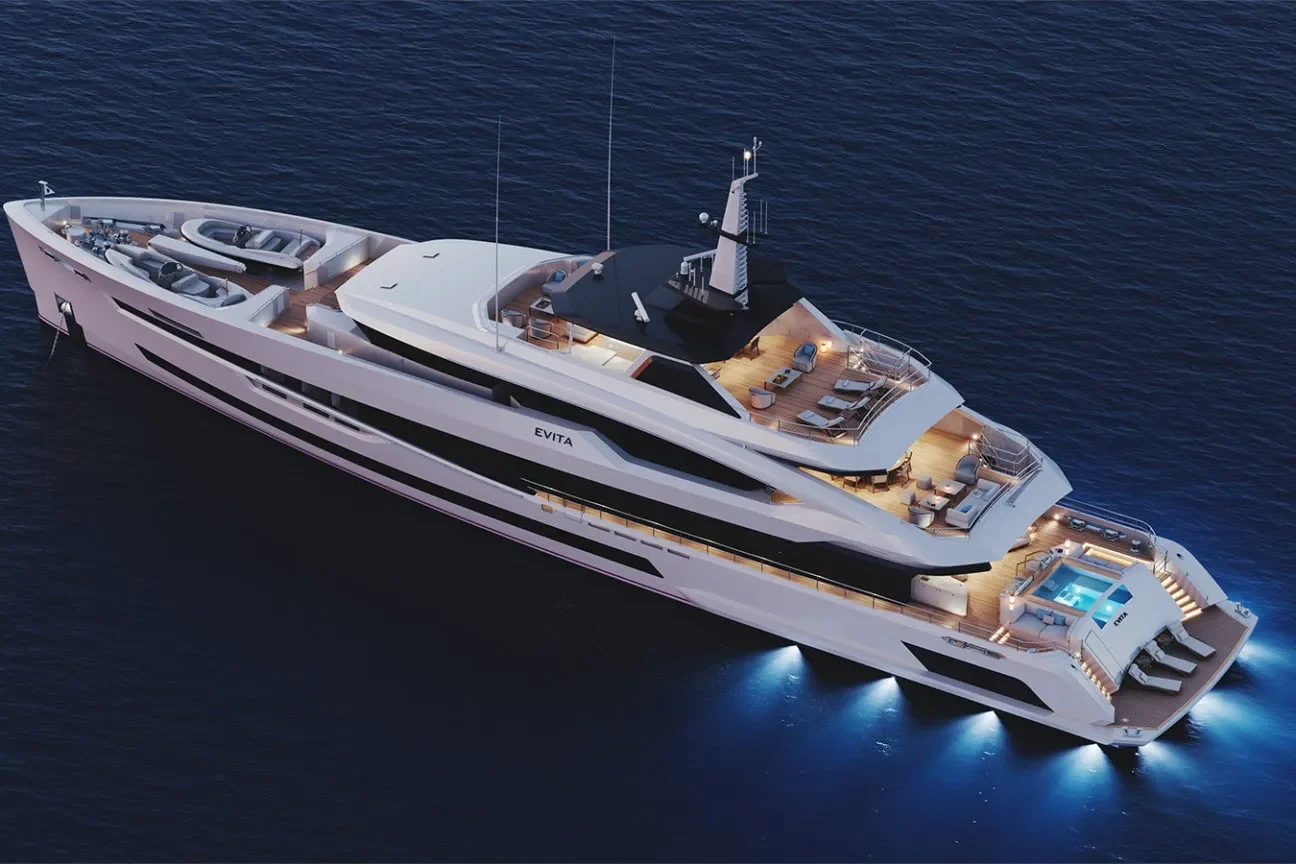 Evening aerial view of a luxury Heesen superyacht cruising with illuminated decks