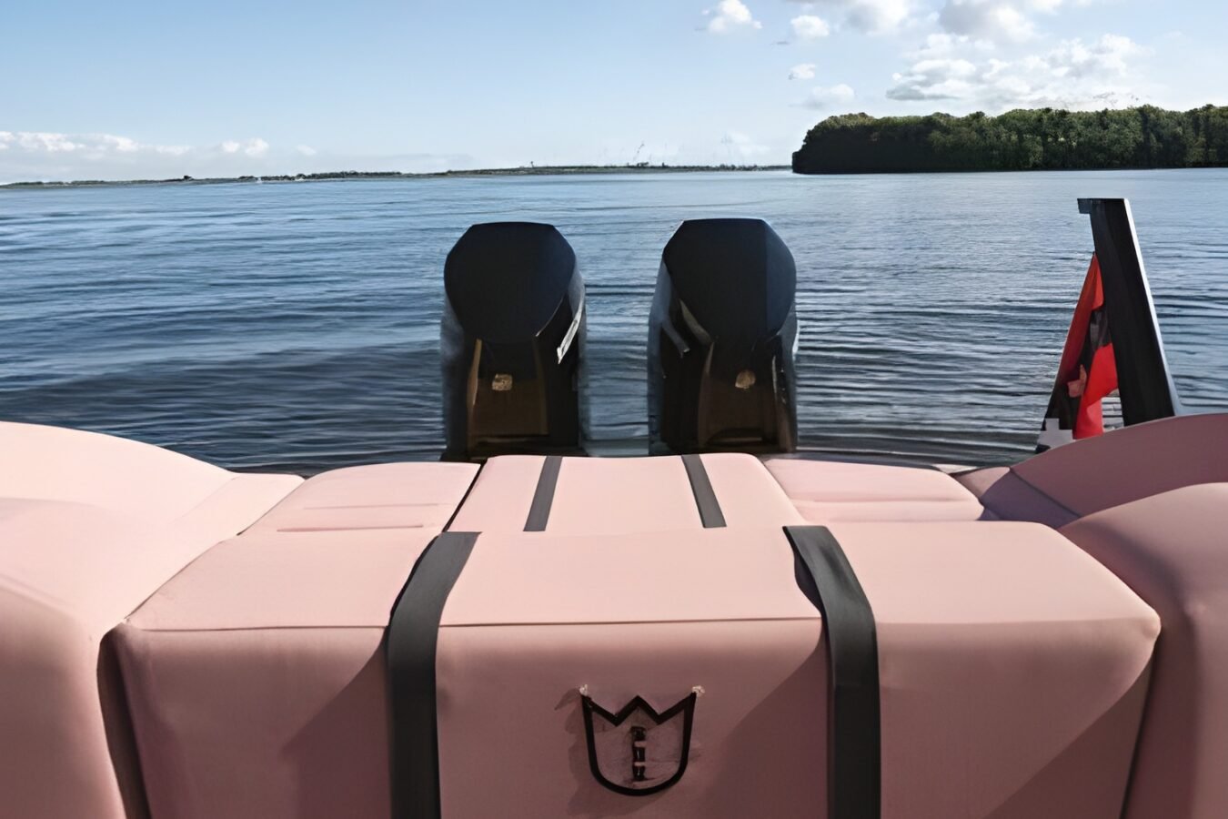 LEKKER 38 yacht aft seating area with cushioned sunpad, twin outboard engines, and open water view