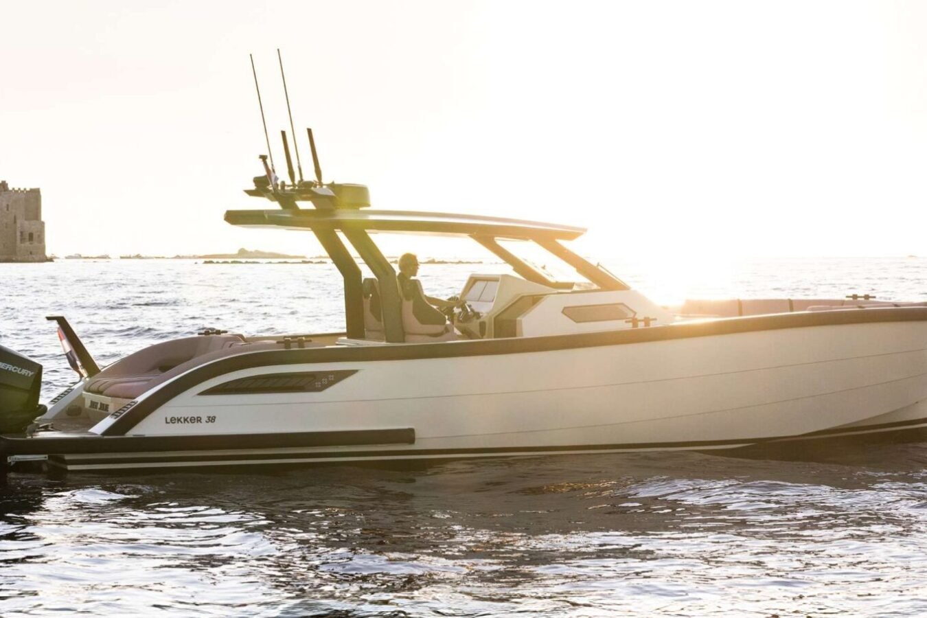 LEKKER 38 yacht at anchor during golden hour, highlighting aluminium hull lines and open deck design