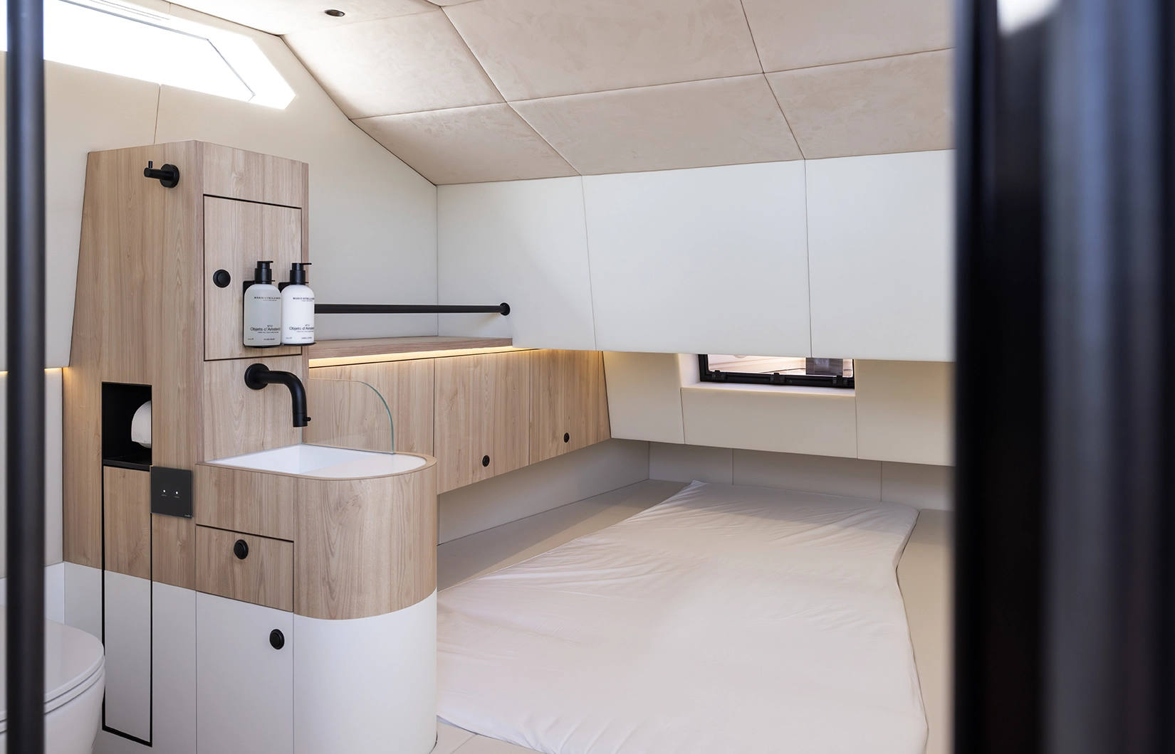 Interior view of the LEKKER 38 yacht showing forward cabin berth and integrated bathroom layout
