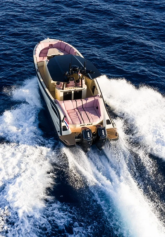 Aerial view of the LEKKER 38 yacht running at speed with twin outboards and wide wake