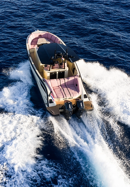 Aerial view of the LEKKER 38 yacht running at speed with twin outboards and wide wake