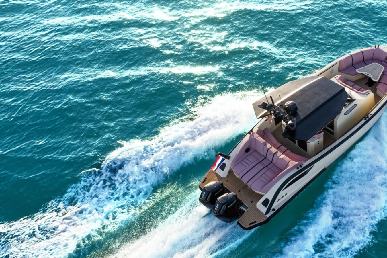 LEKKER 38 yacht cruising at speed with twin outboards, open deck, and wake view from above