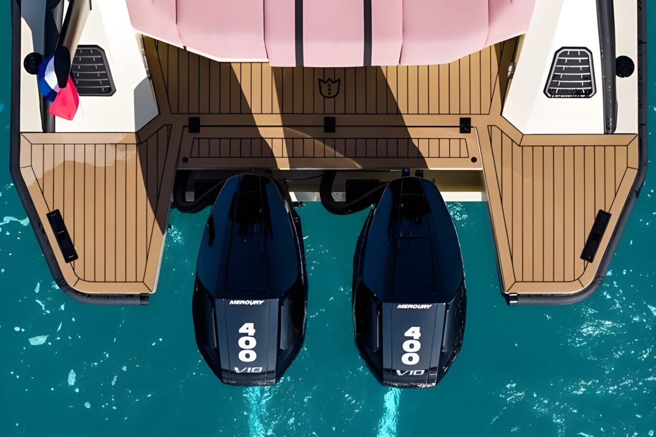 LEKKER 38 yacht stern aerial showing twin Mercury outboard engines and teak swim platform