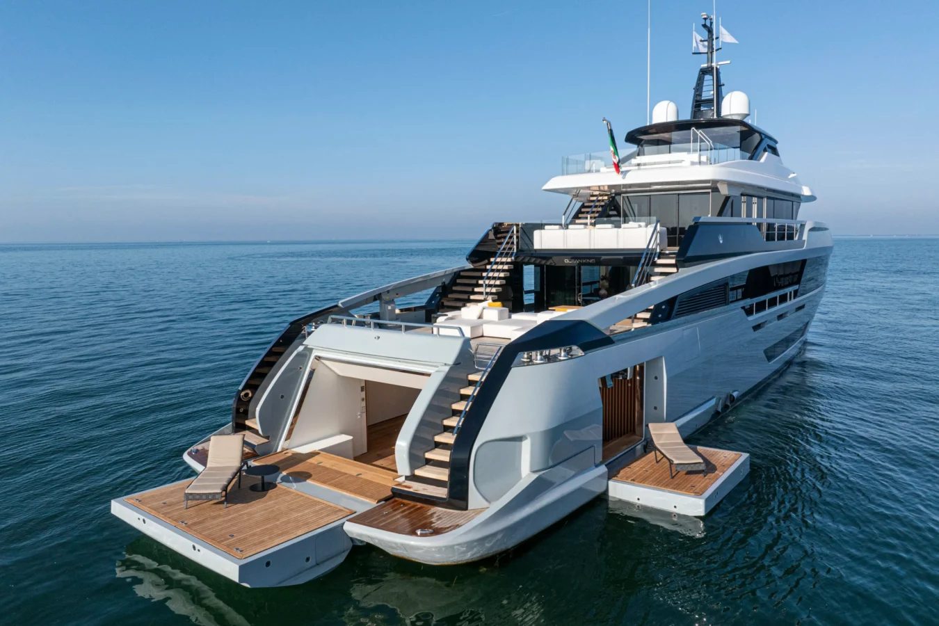 Aft view of the Ocean King DOGE 400 explorer yacht showing the beach club, swim platforms, and expedition-ready stern design.
