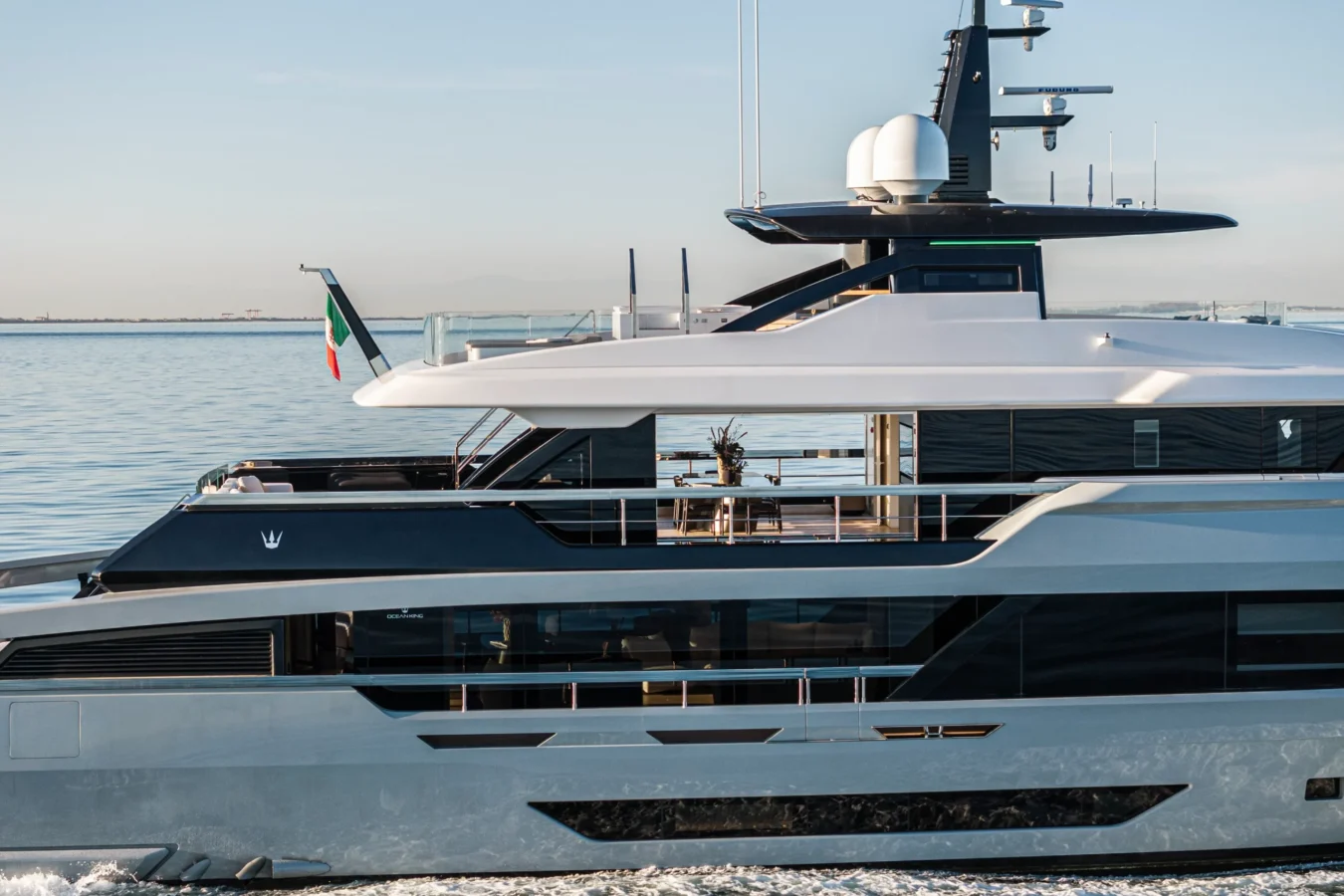 Midship view of the Ocean King DOGE 400 explorer yacht, highlighting the upper deck, radar mast, and modern superstructure.