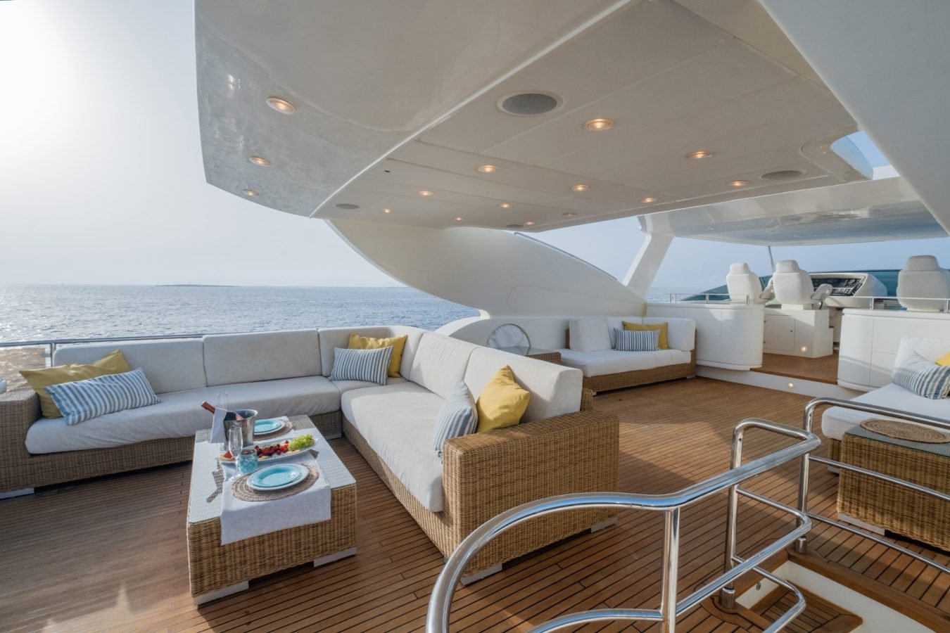 Astondoa 102 GLX My Kirios Yacht For Charter offers a luxe deck with beige sofas, perfect for ocean views and relaxation.