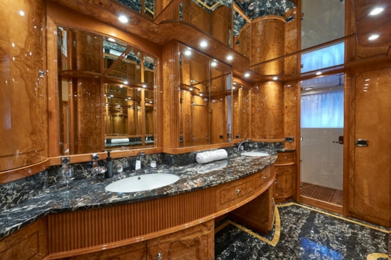 Luxurious bathroom aboard the Astondoa 102 GLX My Kirios Yacht For Charter with wood paneling and marble finishes.