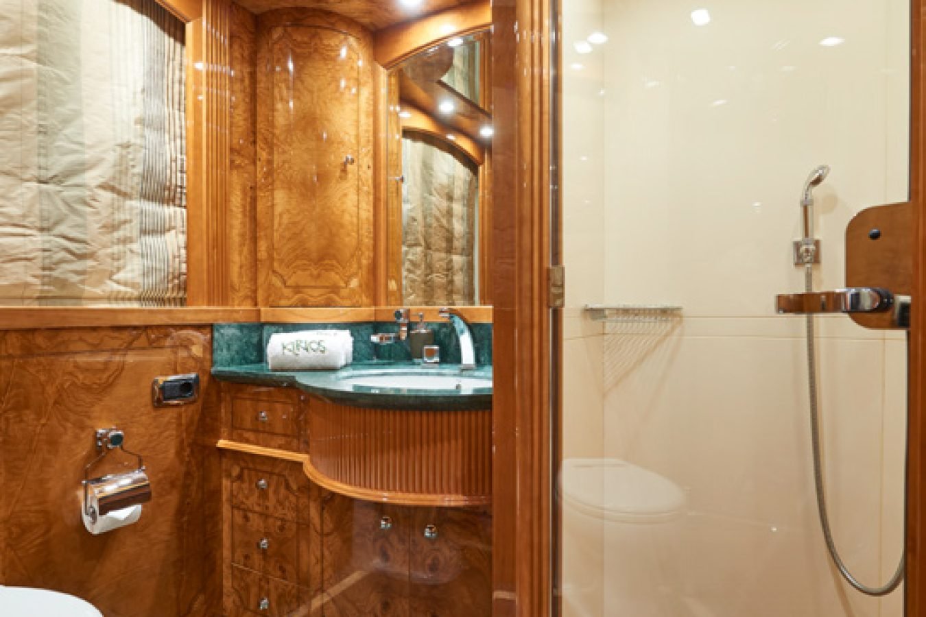 Luxurious wood-paneled bathroom with green marble aboard the Astondoa 102 GLX My Kirios Yacht For Charter.
