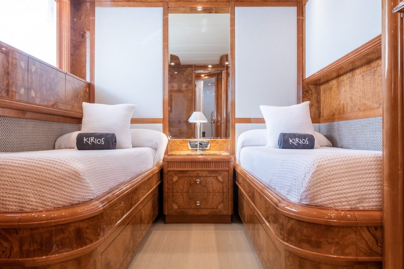 Astondoa 102 GLX My Kirios Yacht For Charter: luxury cabin with twin wood-framed beds, white bedding, and central lamp.