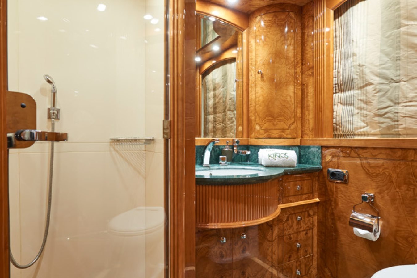 Luxurious bathroom aboard Astondoa 102 GLX My Kirios Yacht For Charter with green marble floor and elegant lighting.