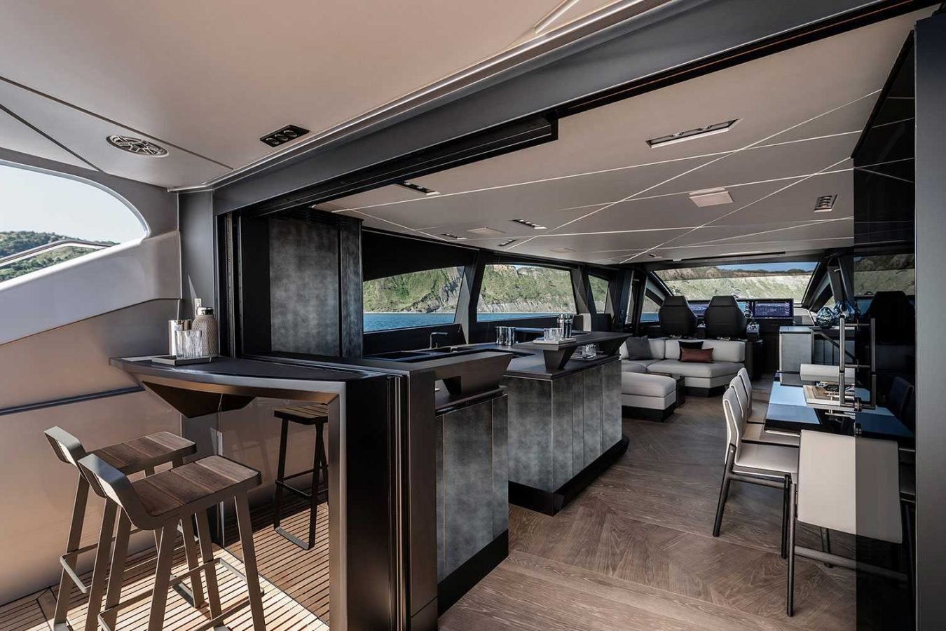Luxury Pershing GTX80 yacht for charter with modern bar, lounge, dining, and Vicky—enjoy water and hillside views.