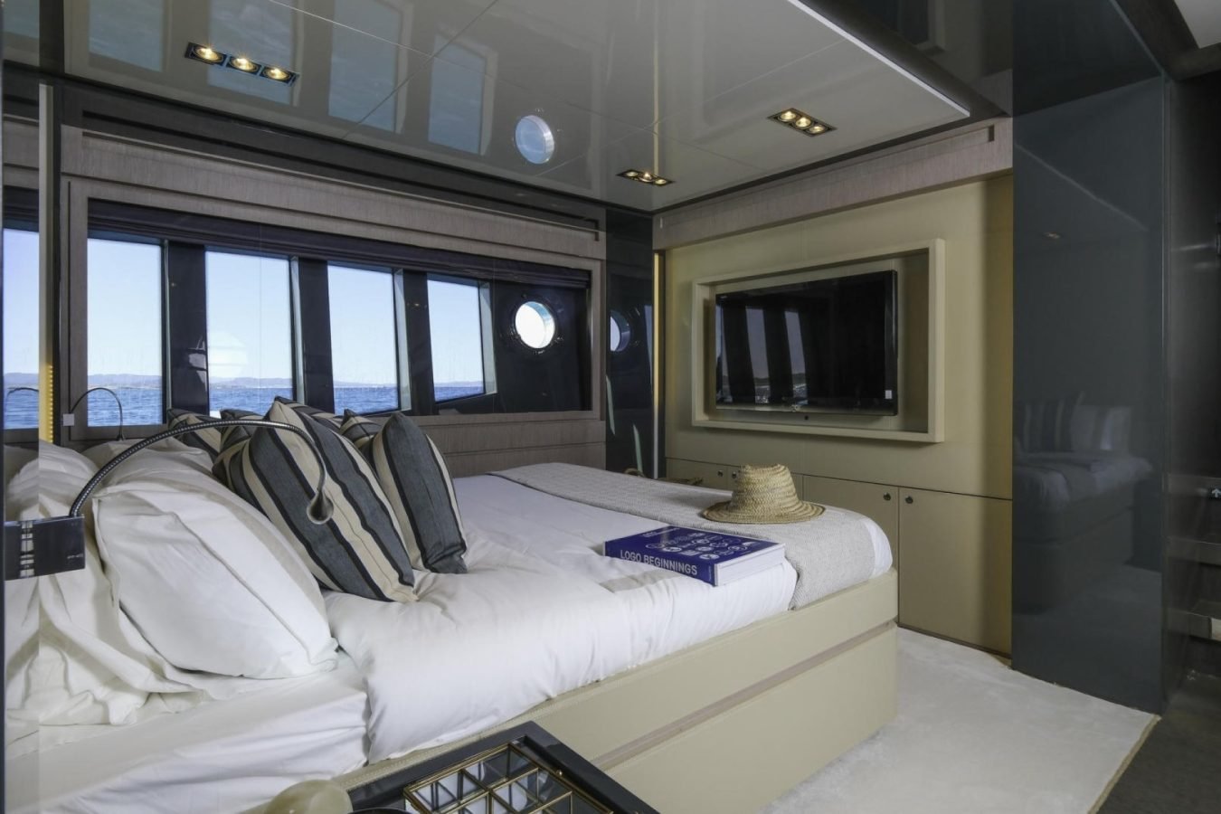 A modern yacht bedroom aboard the Riva 86 Tanit with ocean views—perfect for your next yacht for charter experience.