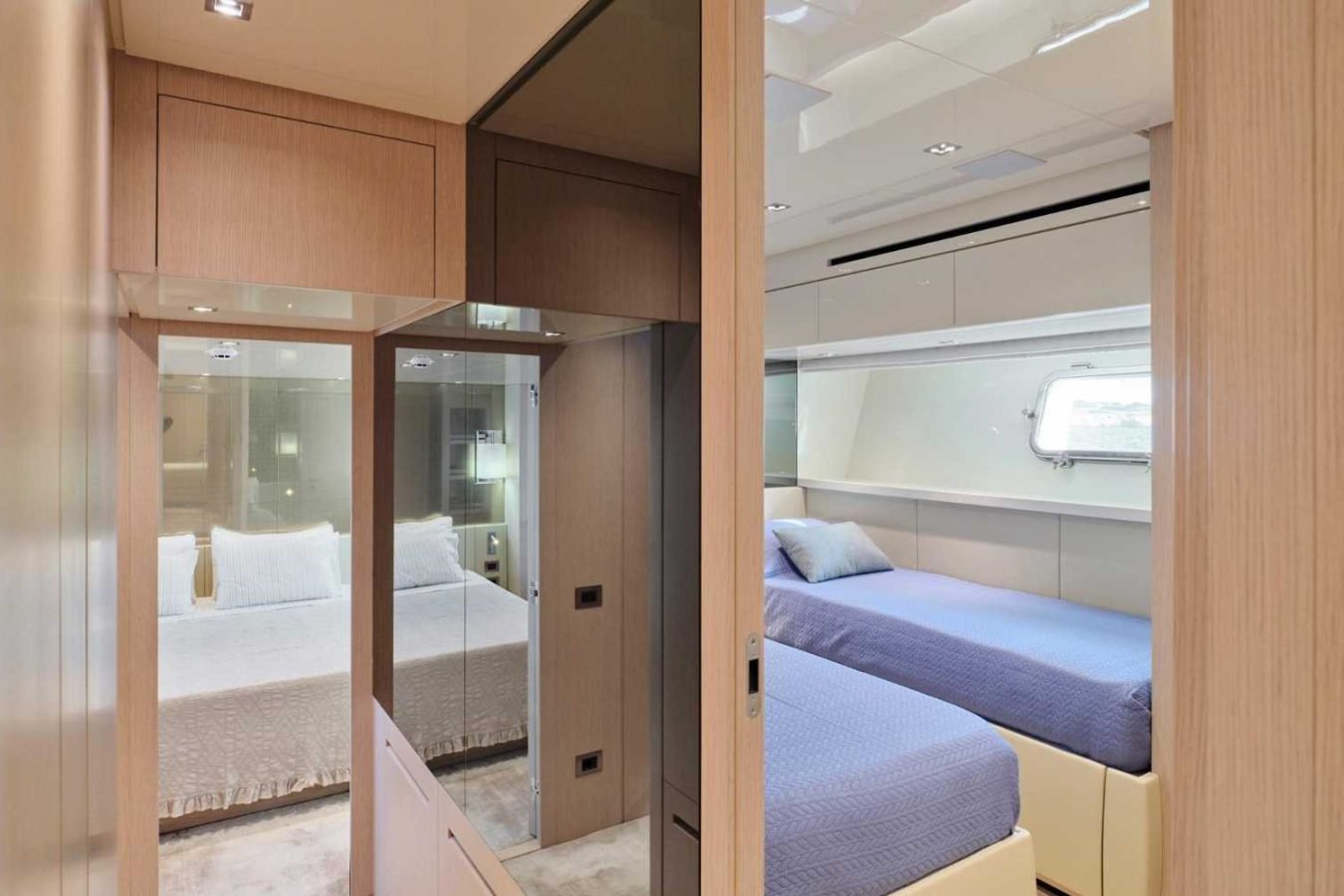 Modern Sanlorenzo SX76 Fuquet Duet yacht cabin with twin and double beds, built-in mirror, window, and neutral tones.