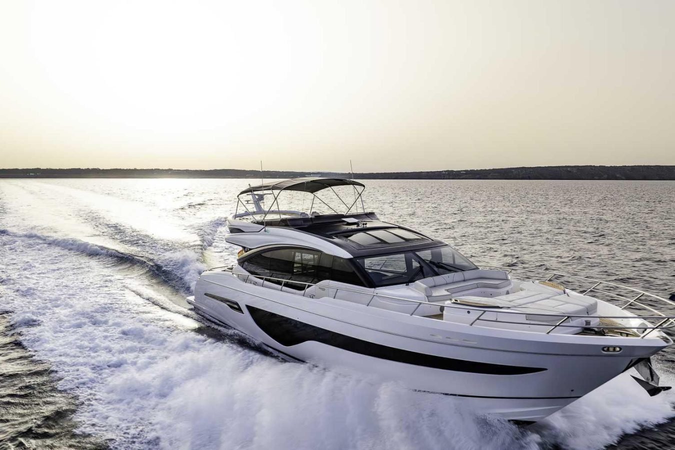 The Princess S78 “Why Knot Yacht” speeds across open water, sunlight reflecting on waves—perfect yacht for charter moments.