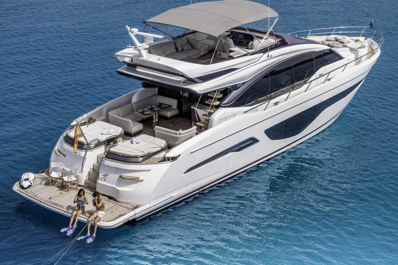 Luxury Princess S78 “Why Knot Yacht” on blue water, with women sunbathing and dining set visible—Yacht for Charter.